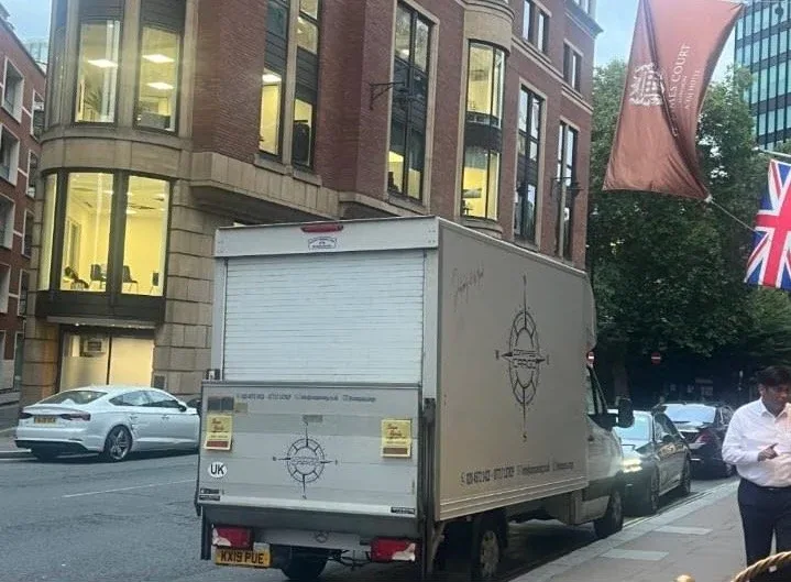 Compass Cargo truck parked outside a London building
