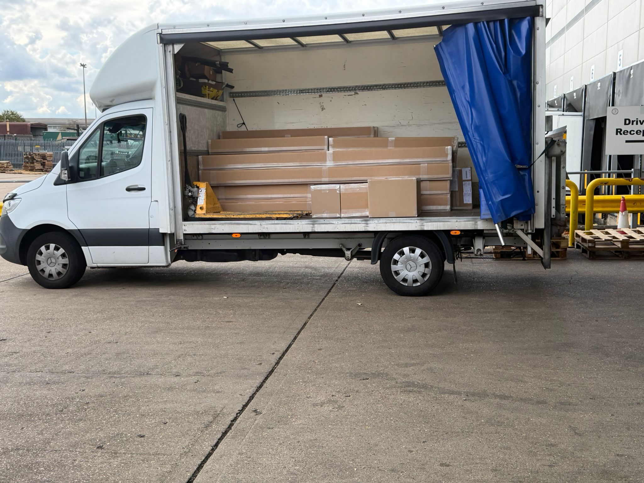 Tail-lift loading a palletised delivery into a Compass Cargo van