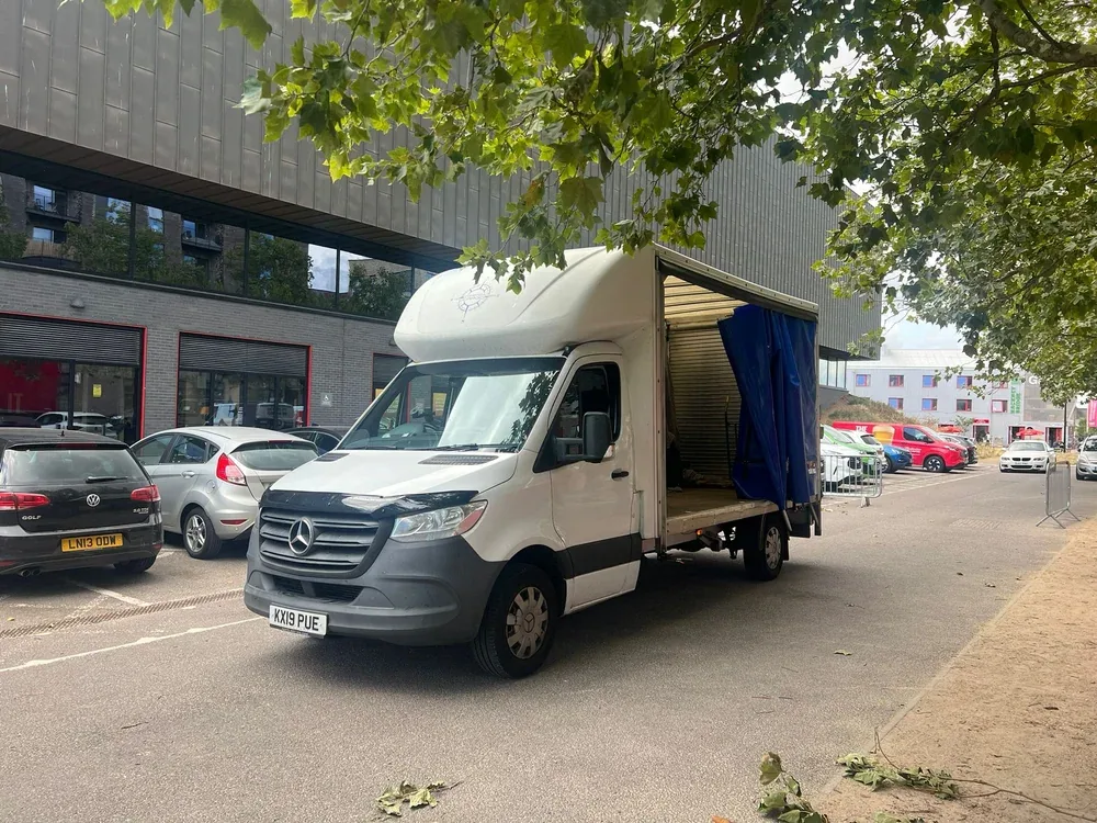 Compass Cargo truck completing a collection outside a commercial building